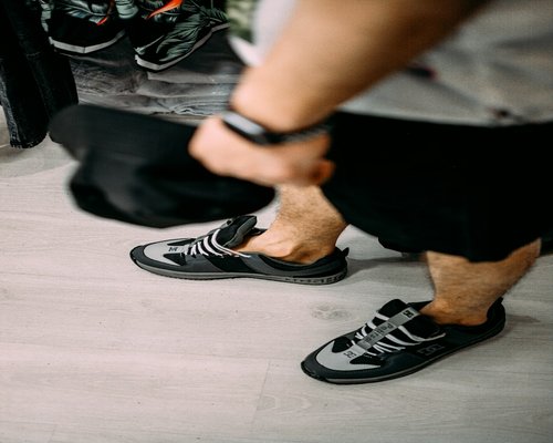 Detail of person tying running shoes preparing for a walk