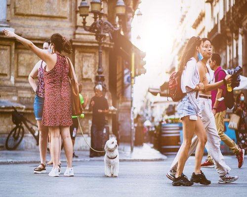 Group of friends walking and laughing together in urban setting