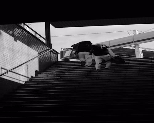 People walking up stairs outdoors in city environment